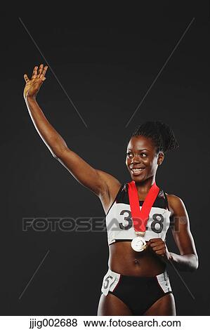 African Female Athlete Wearing Medal and Celebrating View Large Photo Image Stock Photo - African Female Athlete Wearing Medal and Celebrating. Fotosearch