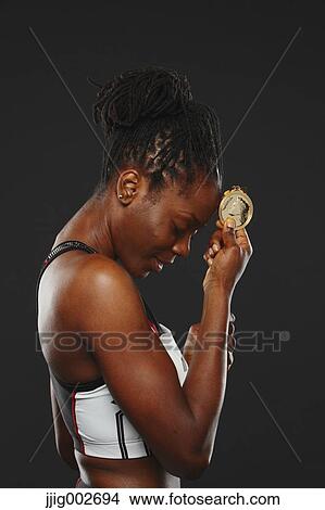 Picture - African Woman athlete with medal. Fotosearch
