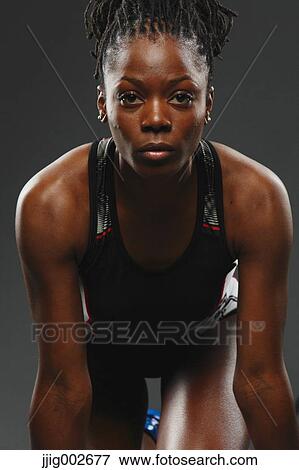 Stock Photo - African Woman Runner Preparing To Start. Fotosearch