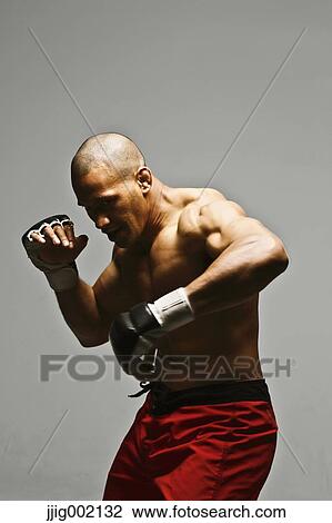 Bald male athlete in a fighting pose View Large Photo Image Stock Image - Bald male athlete in a fighting pose. Fotosearch