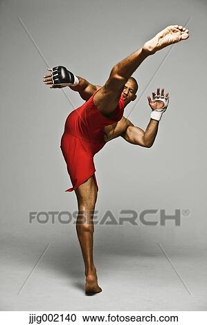Stock Image - Bald male athlete in a fighting pose. Fotosearch