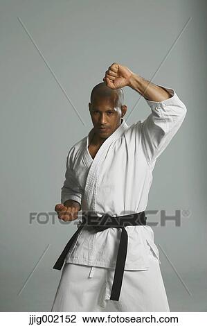 Stock Image - Bald male athlete in a fighting pose. Fotosearch