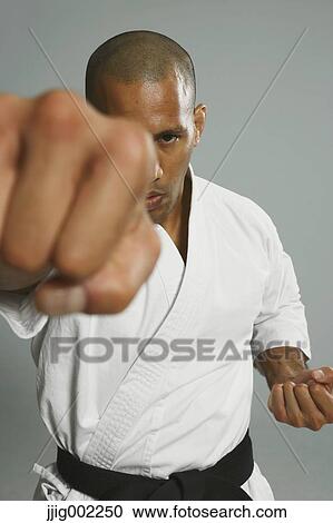 Stock Image - Bald male athlete in a fighting pose. Fotosearch