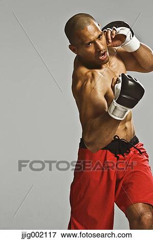 Bald male athlete in a fighting pose View Large Photo Image Stock Photo - Bald male athlete in a fighting pose. Fotosearch