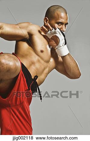 Stock Photo - Bald male athlete in a fighting pose. Fotosearch