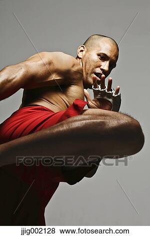 Bald male athlete in a fighting pose View Large Photo Image Stock Photo - Bald male athlete in a fighting pose. Fotosearch
