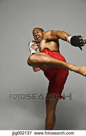 Bald male athlete in a fighting pose View Large Photo Image Stock Photo - Bald male athlete in a fighting pose. Fotosearch
