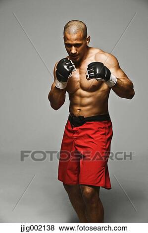 Bald male athlete in a fighting pose View Large Photo Image Stock Photo - Bald male athlete in a fighting pose. Fotosearch