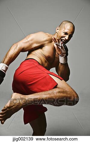 Stock Photo - Bald male athlete in a fighting pose. Fotosearch
