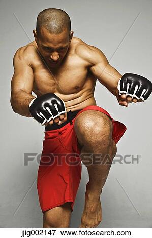 Stock Photo - Bald male athlete in a fighting pose. Fotosearch
