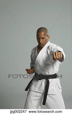 Bald male athlete in a fighting pose View Large Photo Image Stock Photo - Bald male athlete in a fighting pose. Fotosearch