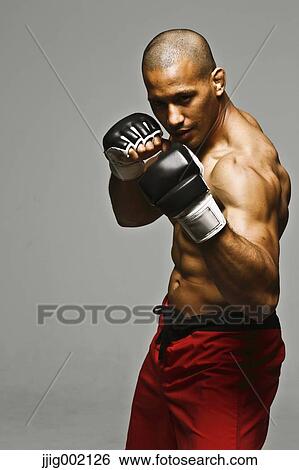Bald male athlete in a fighting pose View Large Photo Image Stock Photograph - Bald male athlete in a fighting pose. Fotosearch