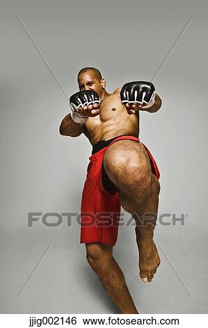 Bald male athlete in a fighting pose View Large Photo Image Stock Photograph - Bald male athlete in a fighting pose. Fotosearch