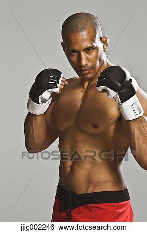 Bald male athlete in a fighting pose View Large Photo Image Stock Photograph - Bald male athlete in a fighting pose. Fotosearch