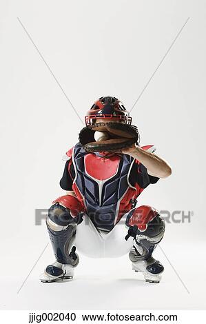 Stock Image - Baseball catcher against white background. Fotosearch