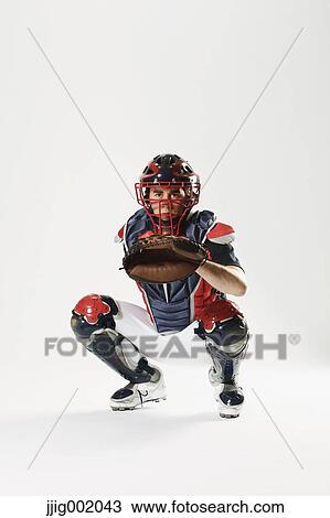 Stock Image - Baseball catcher against white background. Fotosearch
