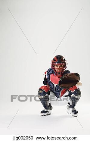 Stock Image - Baseball catcher against white background. Fotosearch