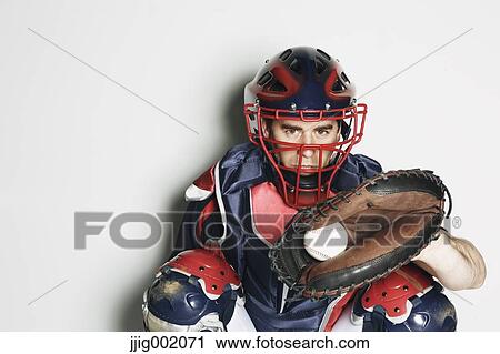 Stock Image - Baseball catcher against white background. Fotosearch