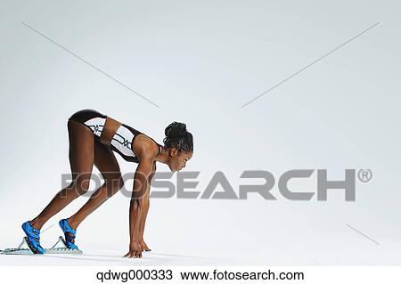 Stock Image - Female Athlete at Starting Block . Fotosearch