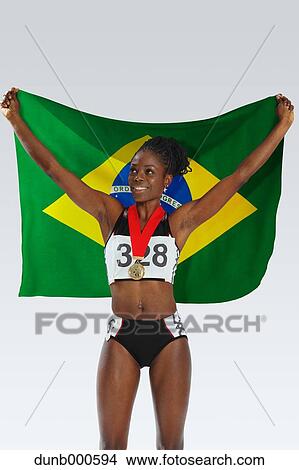 Female Athlete Holding a Brazilian Flag View Large Photo Image Picture - Female Athlete Holding a Brazilian Flag. Fotosearch