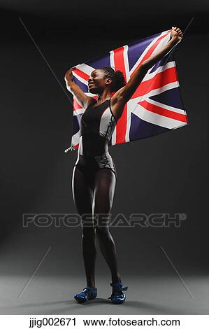 Stock Image - Female Athlete Holding a British Flag. Fotosearch