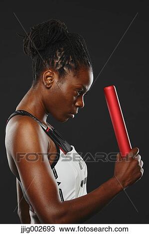 Female Athlete Holding Relay Baton, Focused View Large Photo Image Stock Image - Female Athlete Holding Relay Baton, Focused . Fotosearch