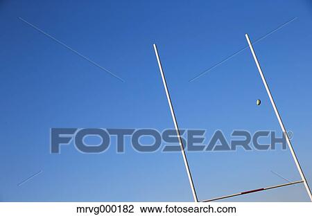 Stock Image - Rugby ball flying through goal. Fotosearch