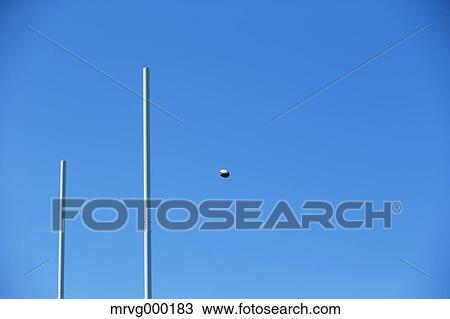 Stock Image - Rugby ball flying through goal. Fotosearch