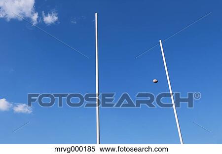 Rugby ball flying through goal View Large Photo Image Stock Photography - Rugby ball flying through goal. Fotosearch