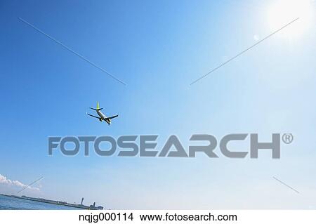 Airplane flying in the sky View Large Photo Image Picture - Airplane flying in the sky. Fotosearch