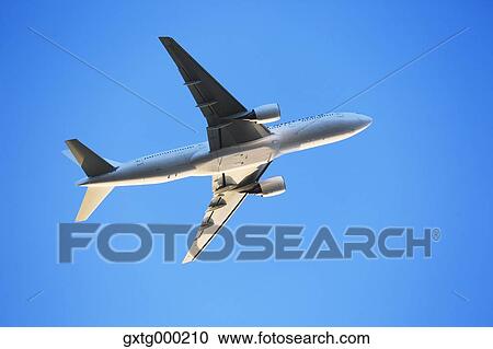 Airplane flying in the sky View Large Photo Image Stock Image - Airplane flying in the sky. Fotosearch