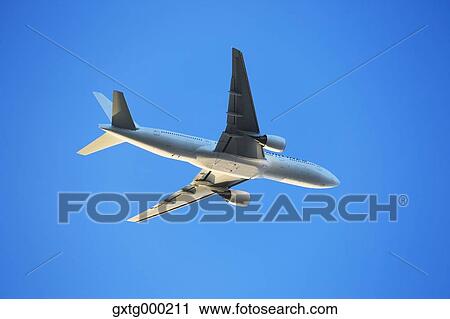 Airplane flying in the sky View Large Photo Image Stock Image - Airplane flying in the sky. Fotosearch