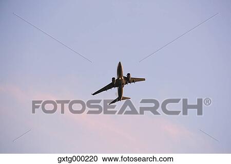 Airplane flying in the sky View Large Photo Image Stock Image - Airplane flying in the sky. Fotosearch