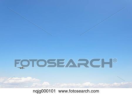 Stock Image - Airplane flying in the sky. Fotosearch