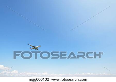 Airplane flying in the sky View Large Photo Image Stock Image - Airplane flying in the sky. Fotosearch