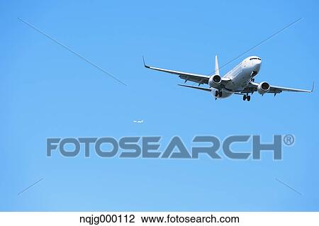 Airplane flying in the sky View Large Photo Image Stock Image - Airplane flying in the sky. Fotosearch