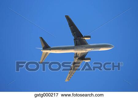 Airplane flying in the sky View Large Photo Image Stock Photo - Airplane flying in the sky. Fotosearch