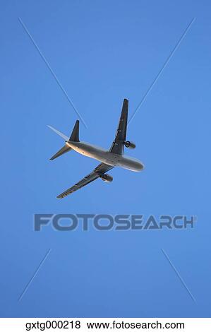 Airplane flying in the sky View Large Photo Image Stock Photo - Airplane flying in the sky. Fotosearch