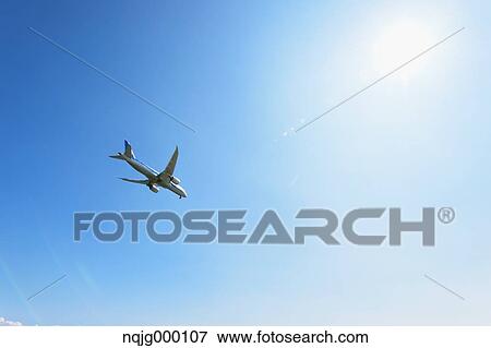 Stock Photo - Airplane flying in the sky. Fotosearch