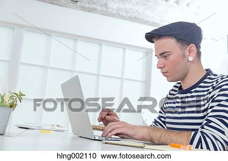 Caucasian man working in modern office View Large Photo Image Stock Image - Caucasian man working in modern office. Fotosearch