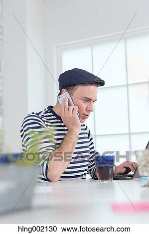 Caucasian man working in modern office View Large Photo Image Stock Image - Caucasian man working in modern office. Fotosearch