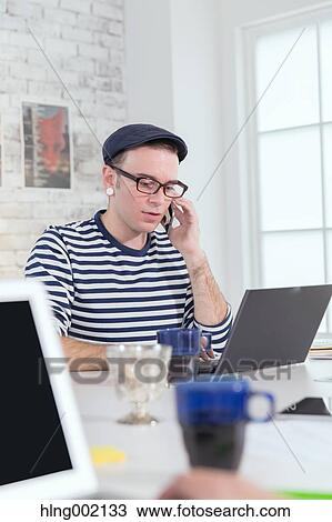 Caucasian man working in modern office View Large Photo Image Stock Image - Caucasian man working in modern office. Fotosearch