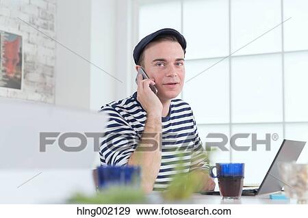 Caucasian man working in modern office View Large Photo Image Stock Photo - Caucasian man working in modern office. Fotosearch