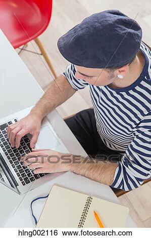 Stock Photograph - Caucasian man working in modern office. Fotosearch