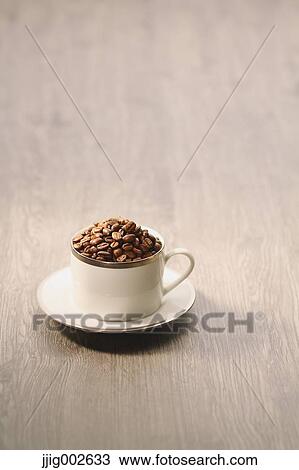 Stock Image - Coffee beans in a cup. Fotosearch