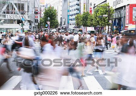 Crowd walking at Shibuya scramble crossing, Tokyo, Japan View Large Photo Image Stock Photograph - Crowd walking at Shibuya scramble crossing, Tokyo, Japan. Fotosearch