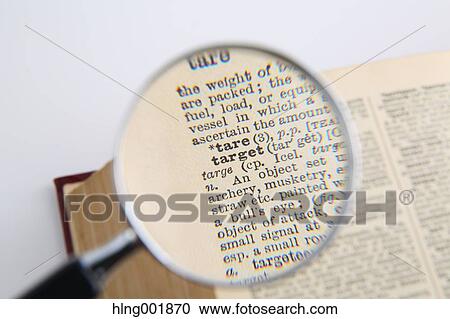Stock Image - Dictionary and magnifying glass. Fotosearch