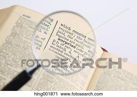 Stock Image - Dictionary and magnifying glass. Fotosearch
