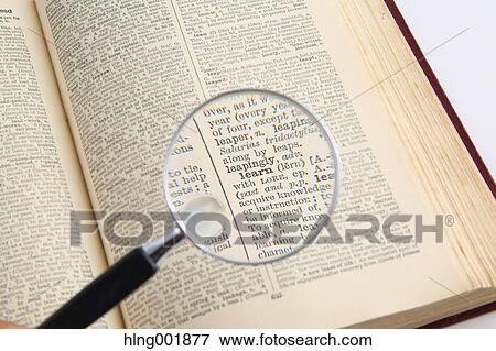 Stock Photo - Dictionary and magnifying glass. Fotosearch