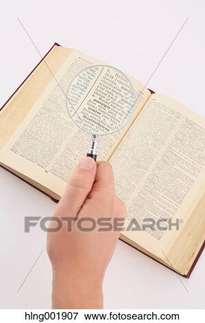 Stock Photo - Dictionary and magnifying glass. Fotosearch